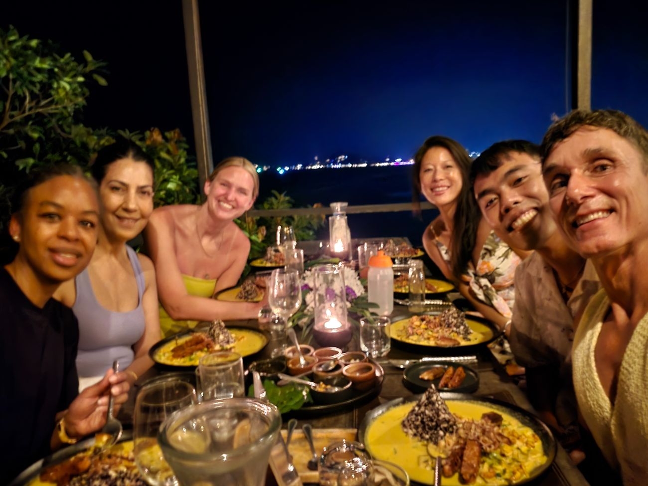 Gruppe beim Abendessen mit Meerblick